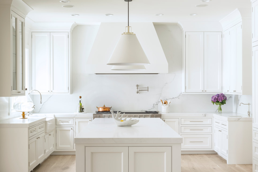 Bright white kitchen with marble backsplash and island tile installed by Star Tile LLC